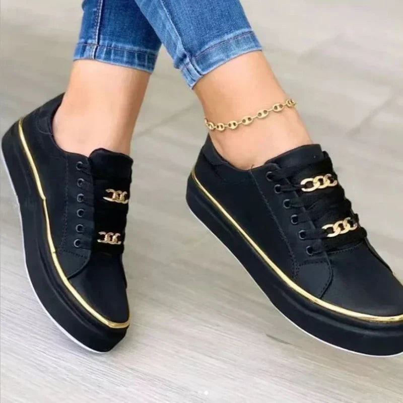 Women's platform sneakers, gold chain accent, white low top, trendy casual shoes for street style.