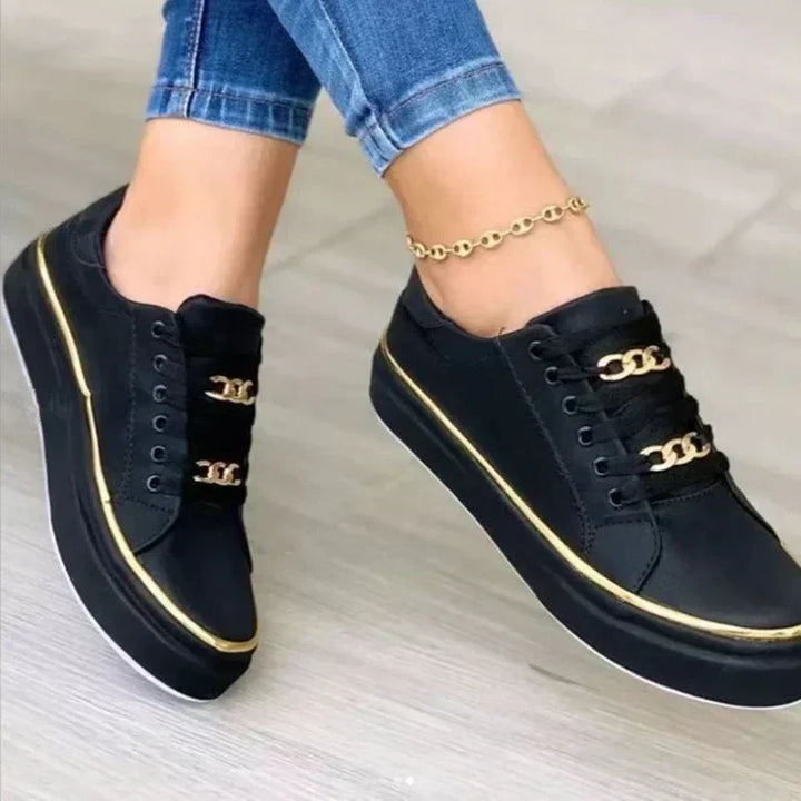 Women's platform sneakers, gold chain accent, white low top, trendy casual shoes for street style.