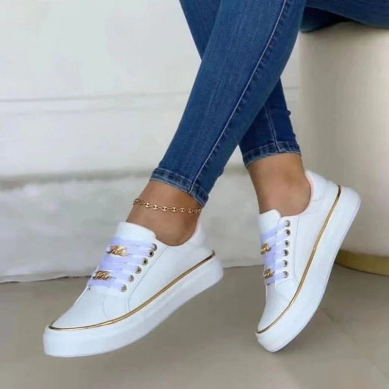 White women's platform sneakers, prominent gold chain, ideal for casual wear and street fashion.
