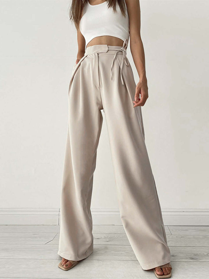 Women's pleated high-waist wide-leg palazzo trousers, elegant & comfortable for versatile styling.