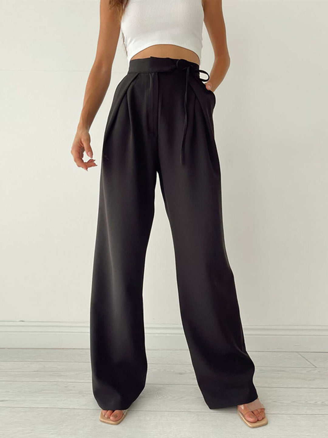 Comfortable brown pleated palazzo trousers for women, high-waist & wide-leg, ideal for summer style.