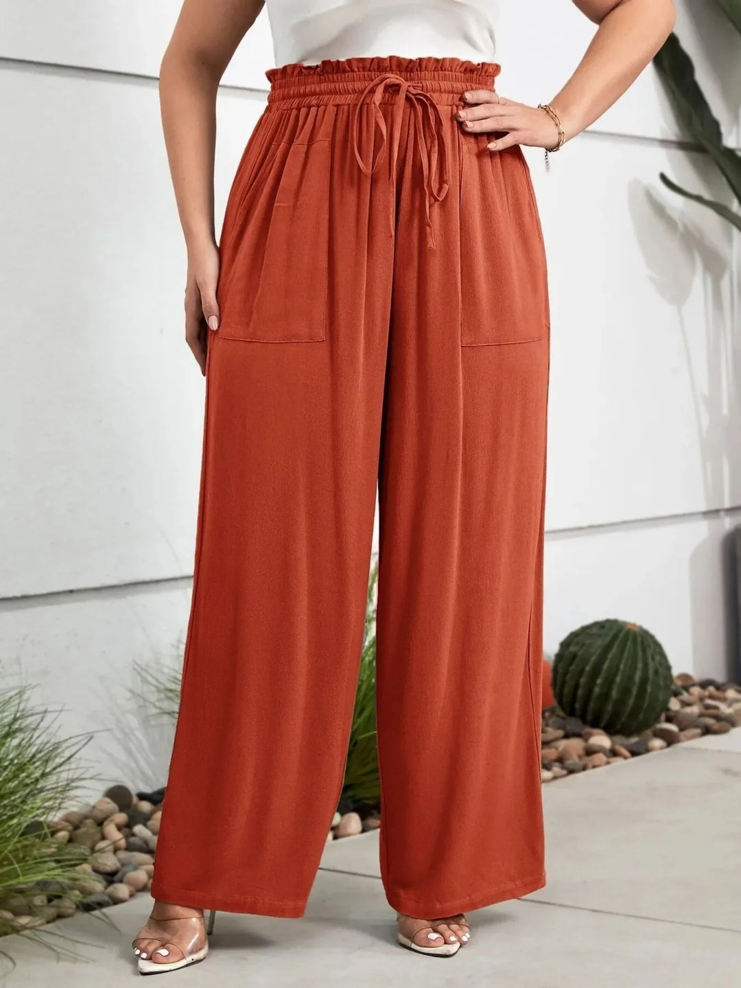 Trendy women's plus size paperbag waist wide leg pants, ideal for summer fashion & beach outings. Loose fit.