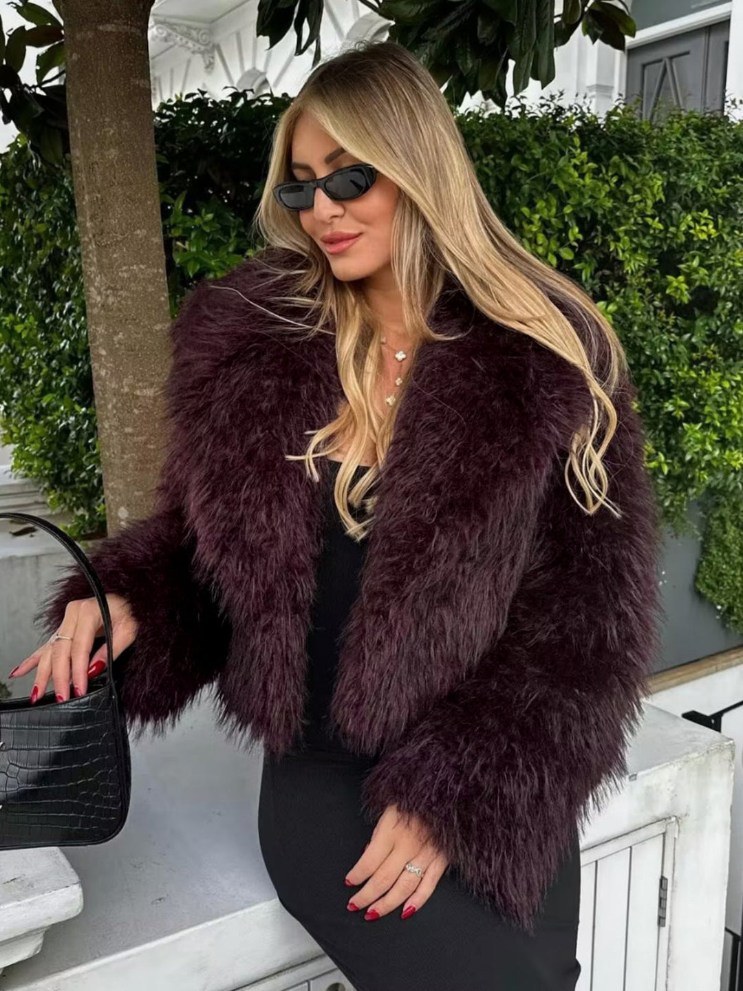 Bold women's burgundy plush cropped statement coat. Fashionable winter jacket for a chic and glamorous look.