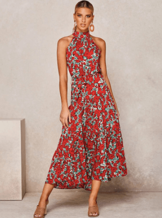 Woman wearing a breezy polka dot halter maxi dress, enjoying a sunny summer day.