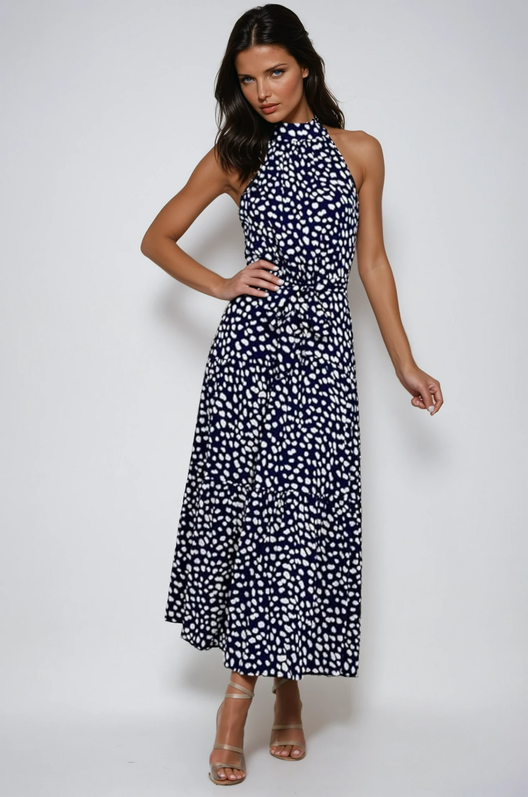 Women's polka dot halter neck midi dress, ideal for elegant summer style.