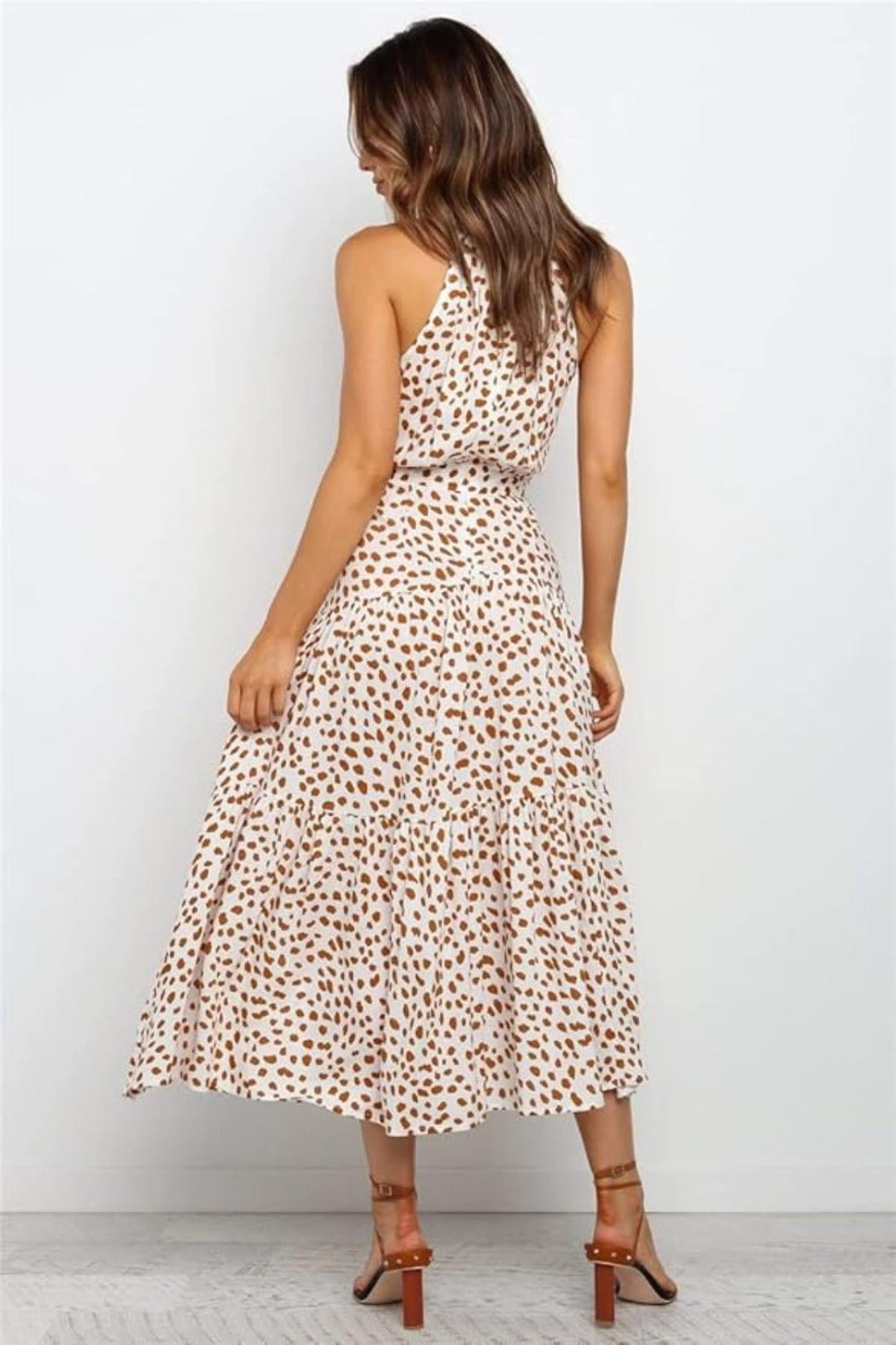 Versatile red polka dot halter neck midi dress, perfect for parties or everyday summer style.