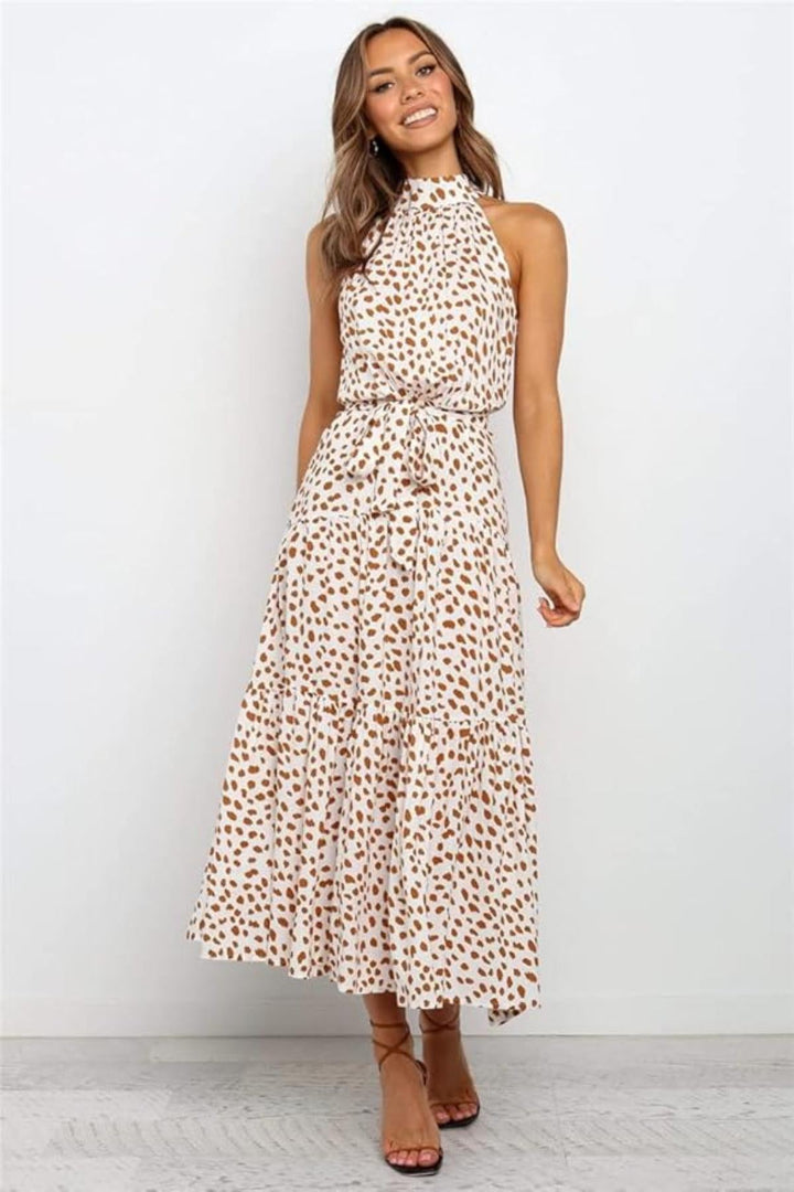 Navy blue polka dot halter midi dress, featuring an adjustable waist for a custom summer fit.