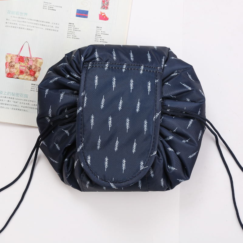 Open drawstring cosmetic bag displaying organized makeup brushes and beauty products.