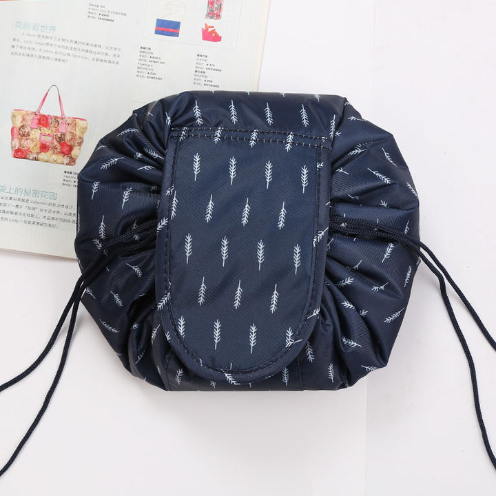 Open drawstring cosmetic bag displaying organized makeup brushes and beauty products.