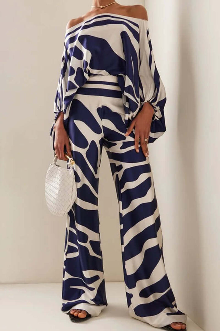 Stylish women's printed off-shoulder top & high waist long sleeve skirt set.