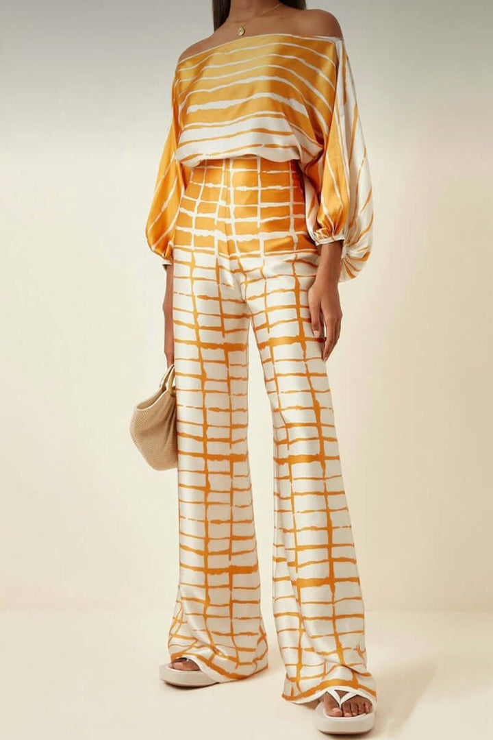 Versatile women's printed polyester off-shoulder top and maxi skirt set.
