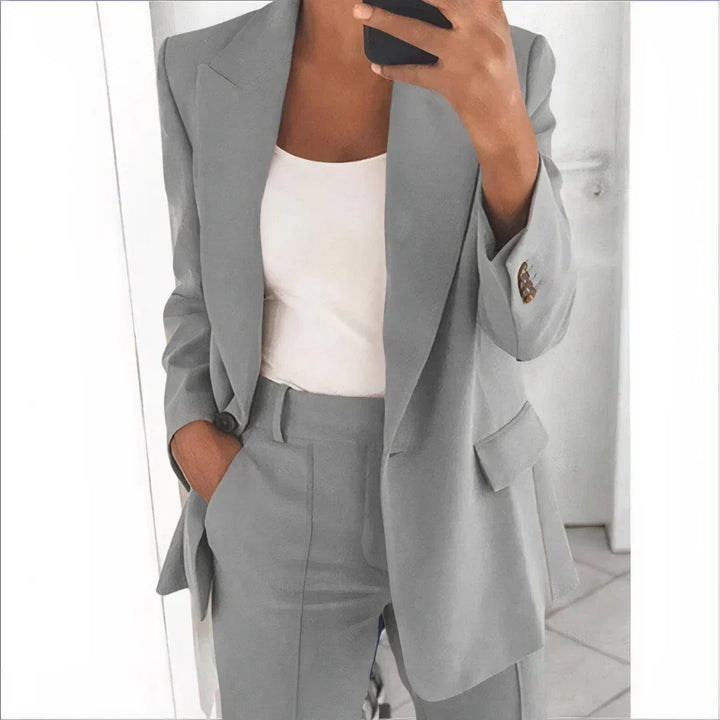 Chic women's tailored blazer and high-waisted pants set. A stylish two-piece outfit for spring and summer fashion.