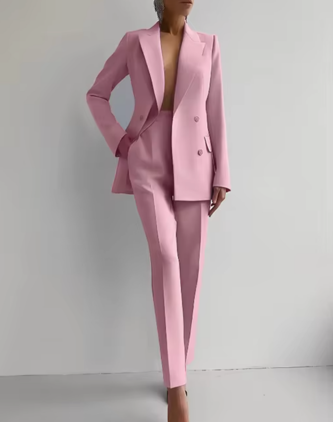 Women's professional tailored pantsuit. Elegant two-piece blazer and trousers for business wear and office attire.