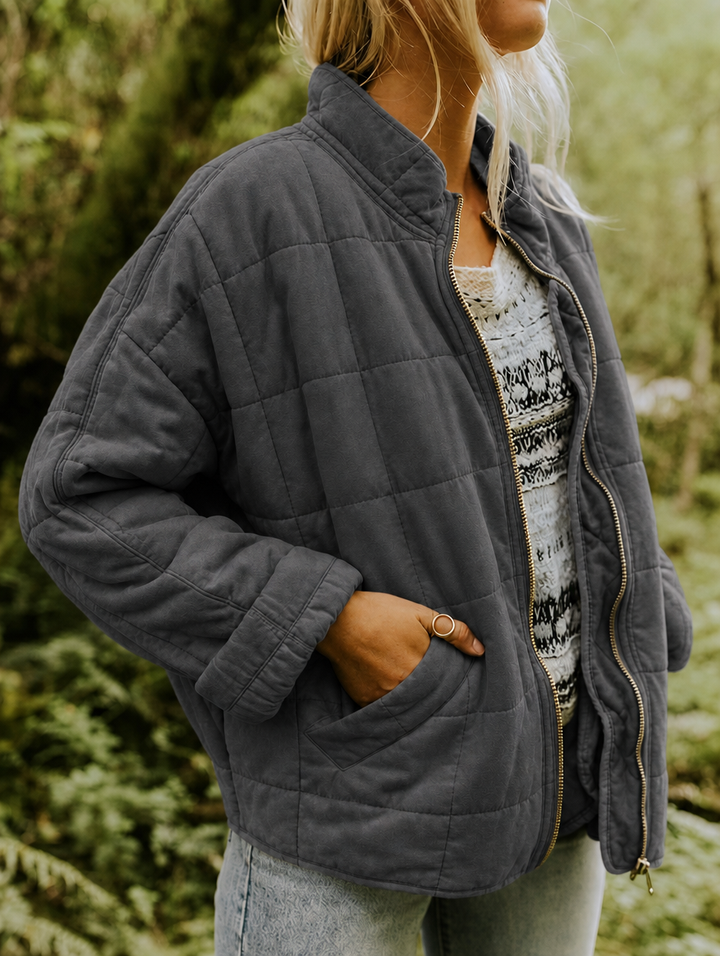 Close-up of women's diamond quilted jacket texture, showcasing casual style & quality fabric.