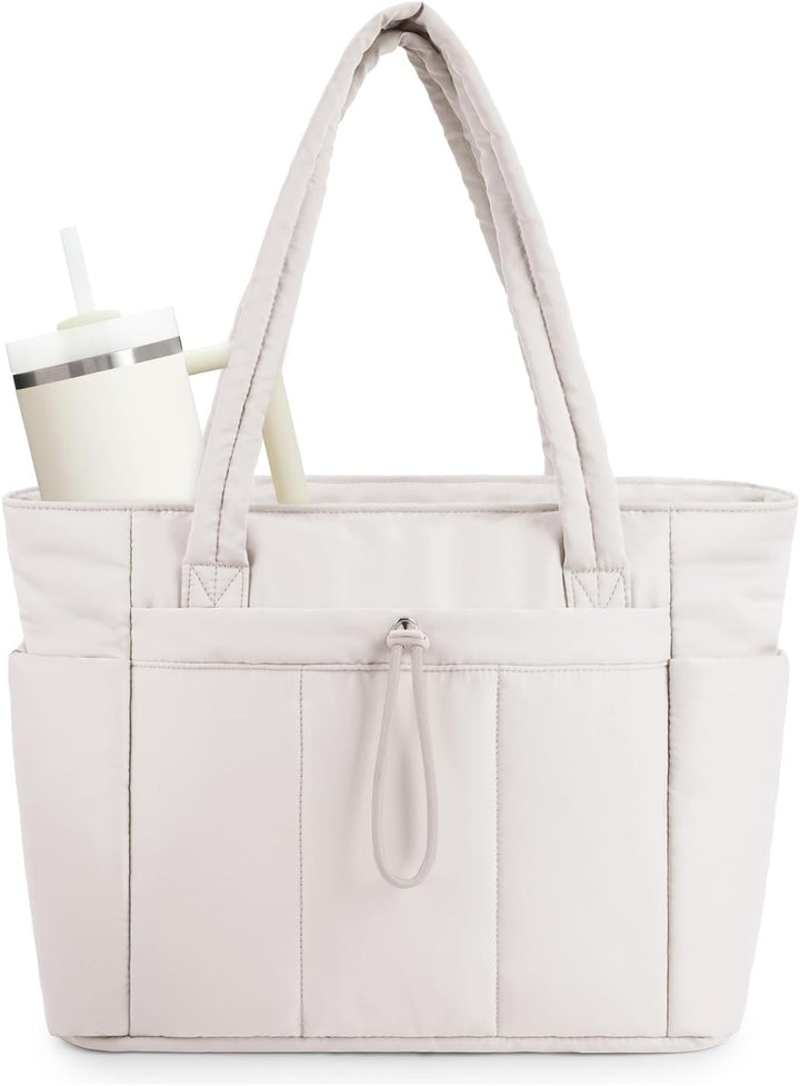 Stylish women's travel tote with laptop sleeve, cup holder, & luggage sleeve for organized commuting.