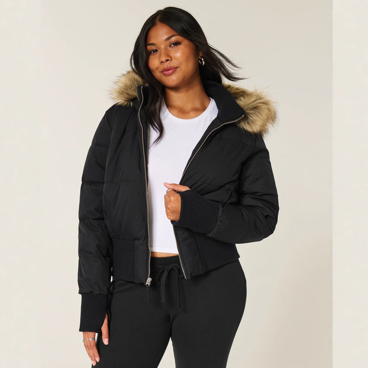 Warm women's quilted jacket with a versatile removable hood, ideal for changing cold weather conditions.