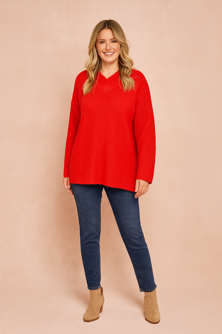 Women's red relaxed fit V-neck oversized sweater. Cozy, stylish, and comfortable for autumn & winter fashion.