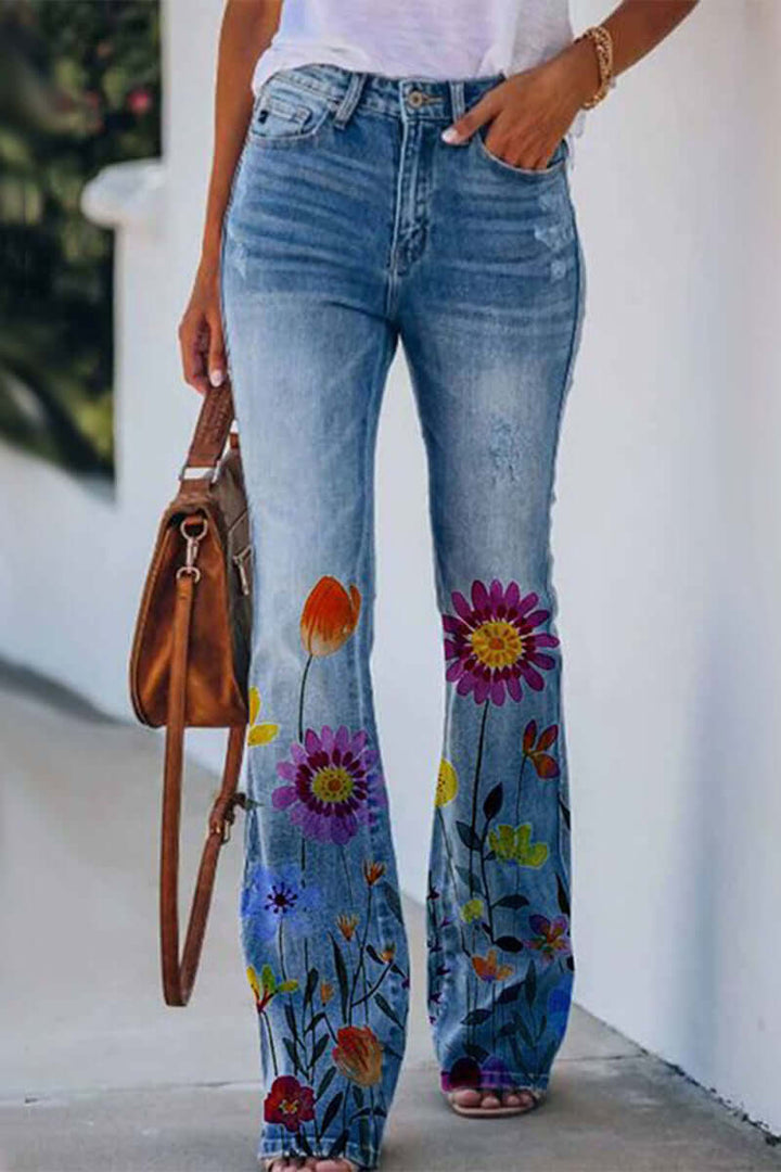 Close-up of intricate floral embroidery on stylish women's regular fit denim jeans.