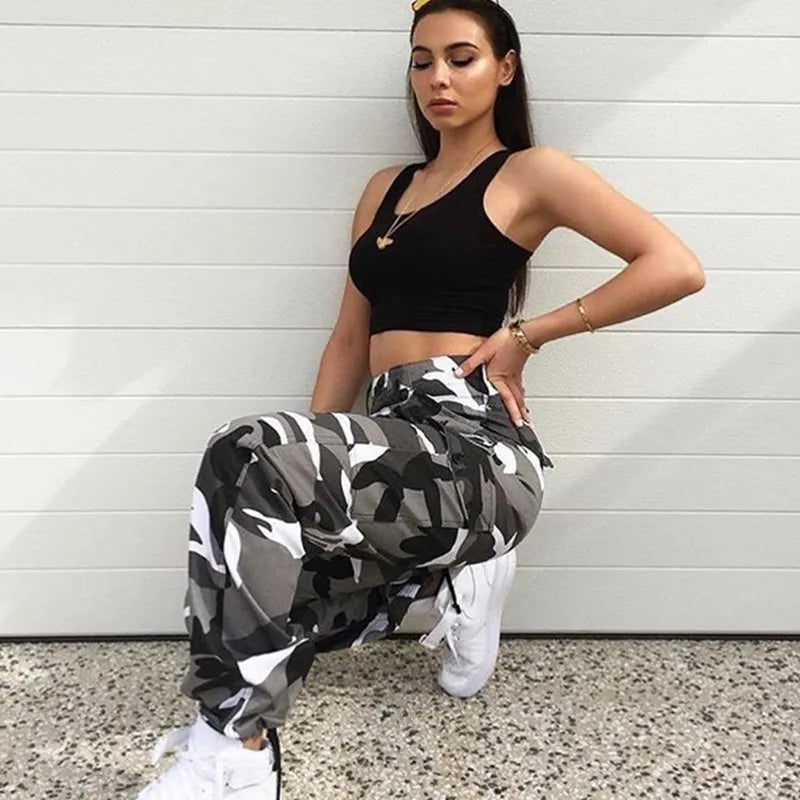 Trendy women's baggy camo cargo pants styled for urban streetwear, featuring comfortable relaxed fit for casual wear.