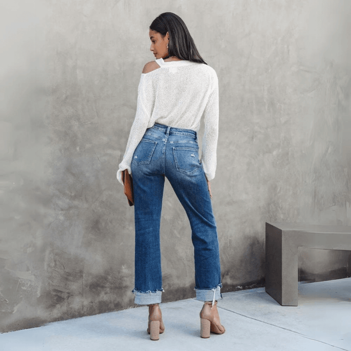 Comfortable women's relaxed fit denim jeans featuring a unique irregular waist design for a trendy look.