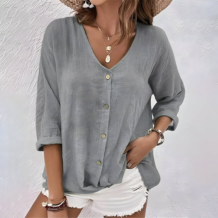 Effortlessly chic women's relaxed button-up blouse. Long sleeve top combines comfort, elegance, and workwear style.