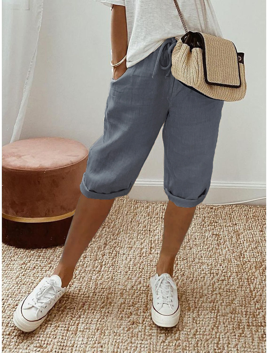 Stack of colorful women's relaxed fit capri pants, comfortable and stylish for everyday wear.