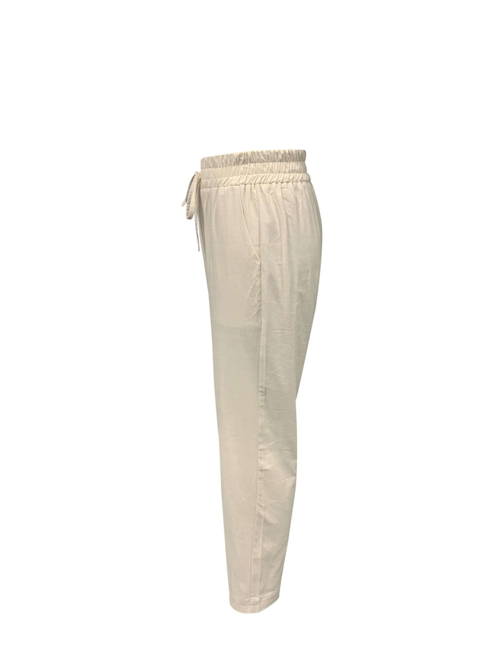 Close-up of women's relaxed fit cotton joggers, detailing the drawstring waist and stylish cuffed hem.