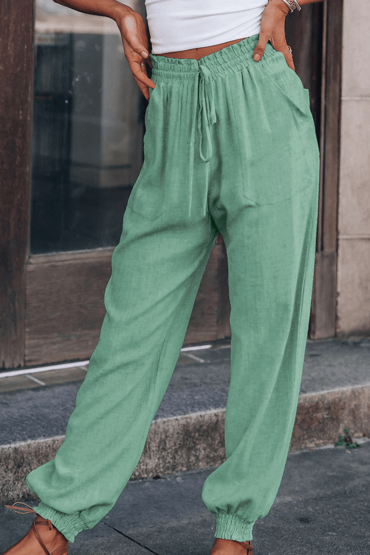 Stylish woman wearing versatile relaxed fit Harlan trousers, showcasing casual fashion and comfort.