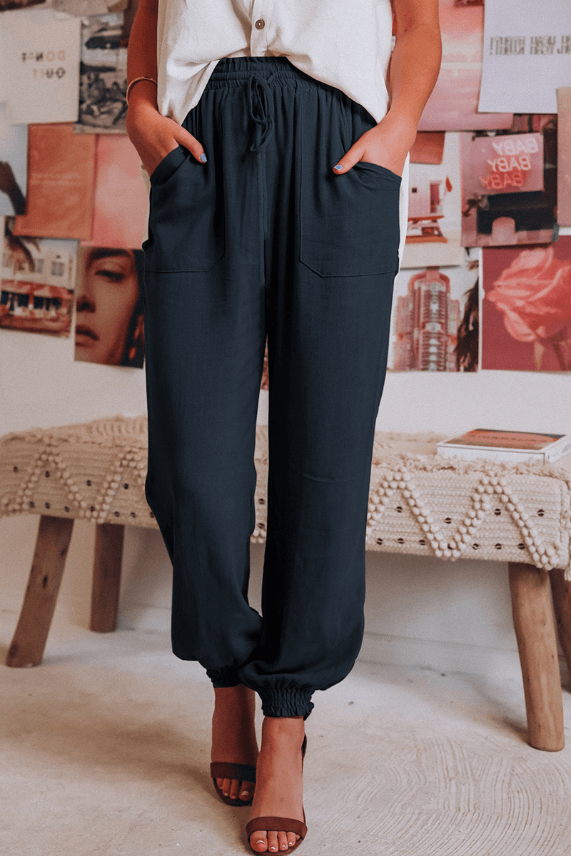 Relaxed fit women's Harlan trousers, featuring a comfortable mid-waist and practical drawstring design.