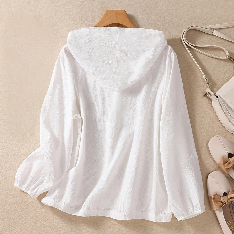 Versatile women's hooded shirt with a relaxed fit, a comfortable long sleeve top for various styles.