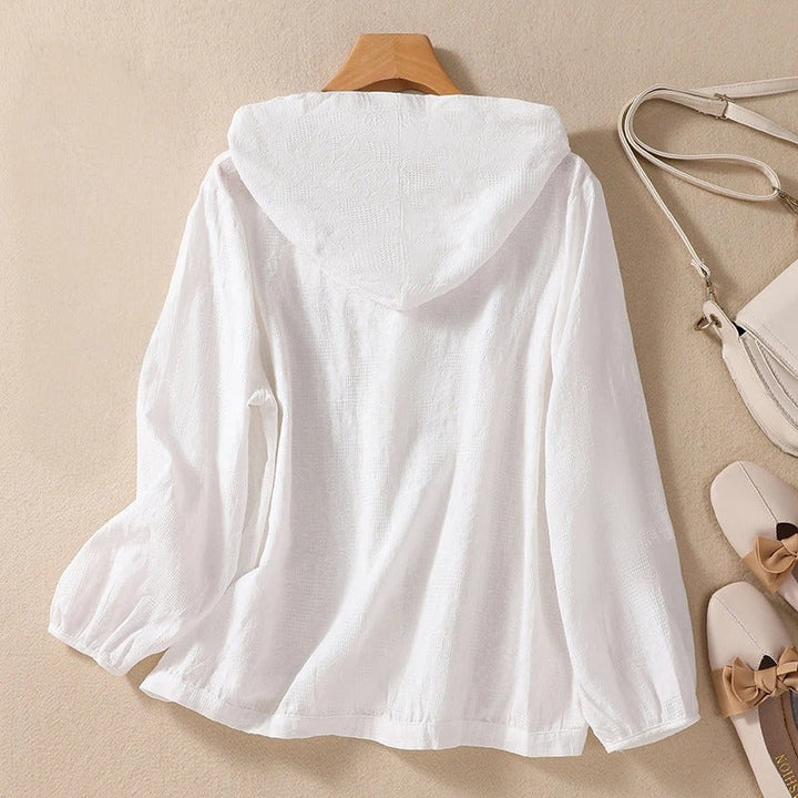 Versatile women's hooded shirt with a relaxed fit, a comfortable long sleeve top for various styles.