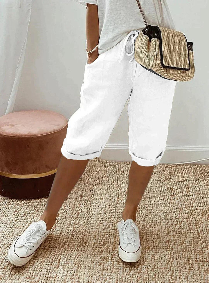 Woman in comfortable linen capri pants, showing relaxed fit and breathable fabric ideal for warm weather.