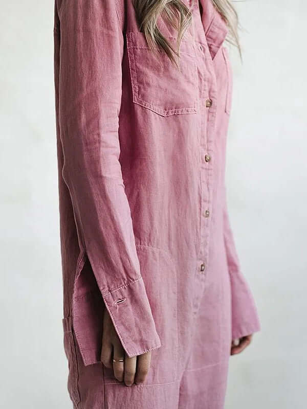 Woman wearing a relaxed fit linen jumpsuit. Straight leg, long sleeve, button-down. Comfortable for casual summer days.