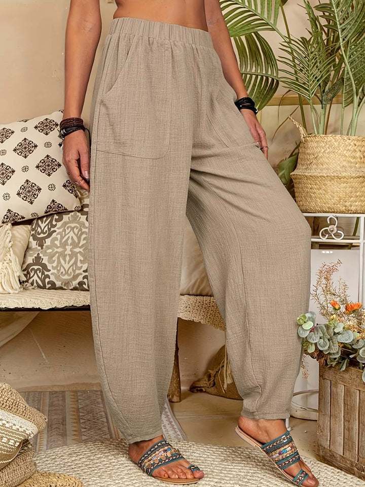 Women's relaxed fit linen trousers with pockets, ideal for comfortable summer casual wear.