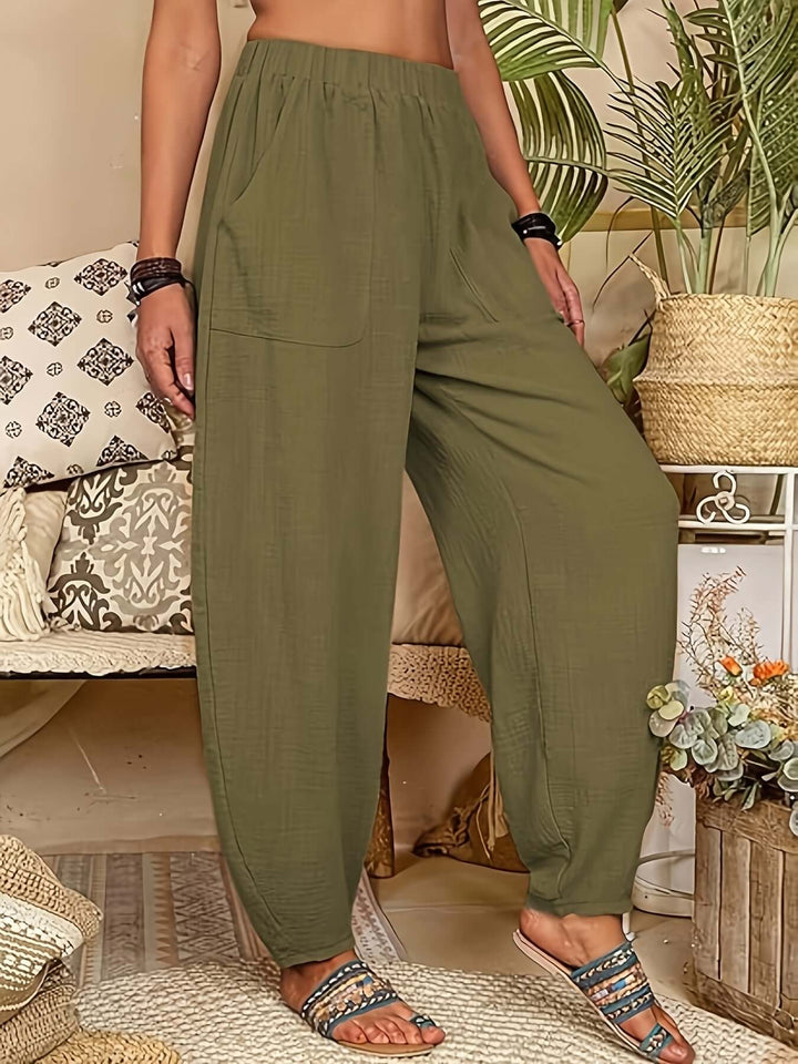 Women's breathable linen trousers, relaxed fit with side pockets, essential for warm weather fashion.