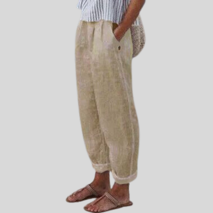 Women's relaxed fit linen trousers with stylish folded hem, perfect for comfortable summer casual wear.