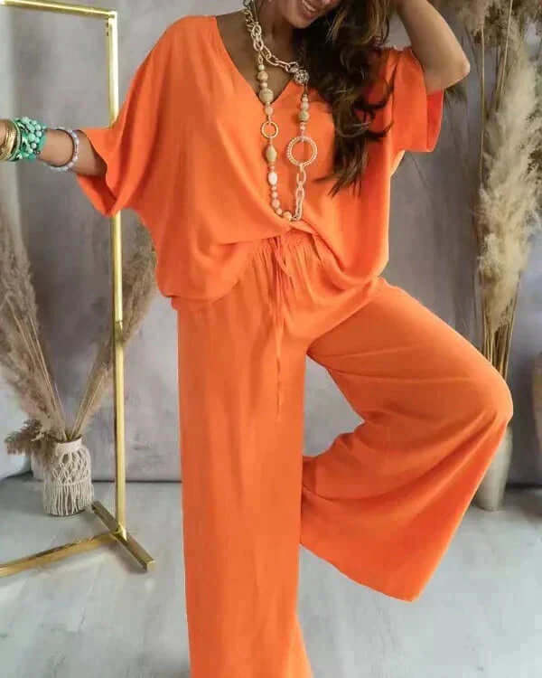 Soft fabric women's loungewear set, a comfortable two-piece with relaxed fit, V-neck top & wide-leg pants for sleep.