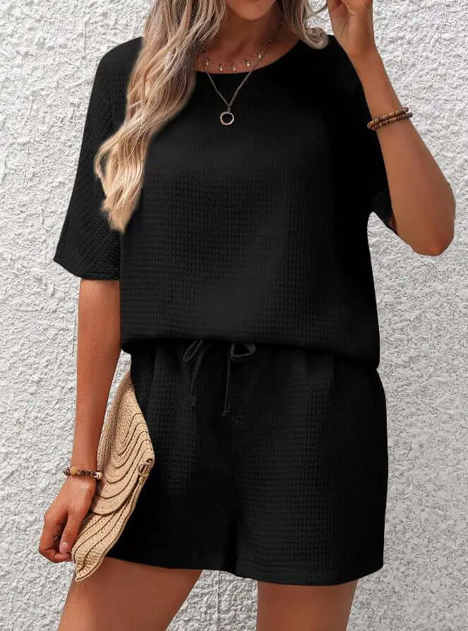 Women's relaxed fit two-piece lounge set in soft polyester for comfortable casual wear and everyday outfits.