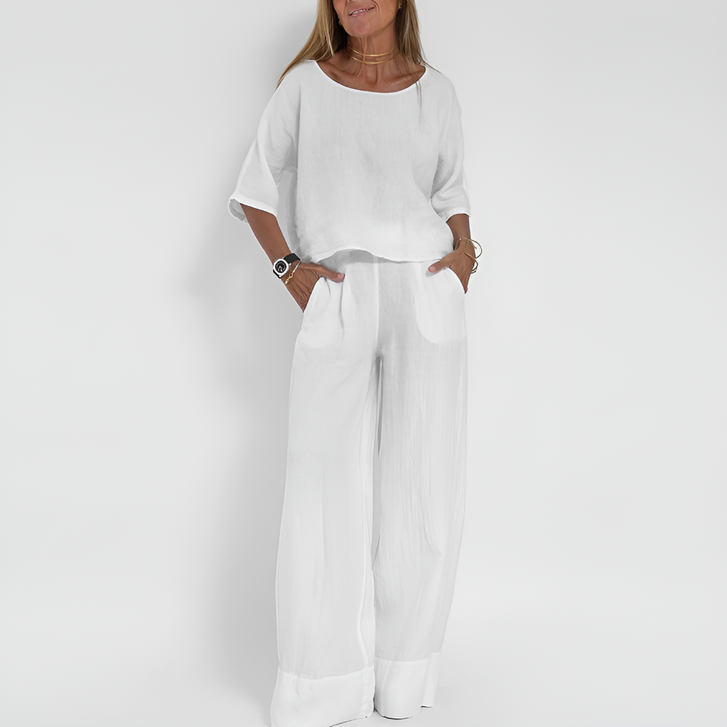 Woman wearing a relaxed fit two-piece summer outfit. Comfortable wide-leg pants & matching top for warm weather.