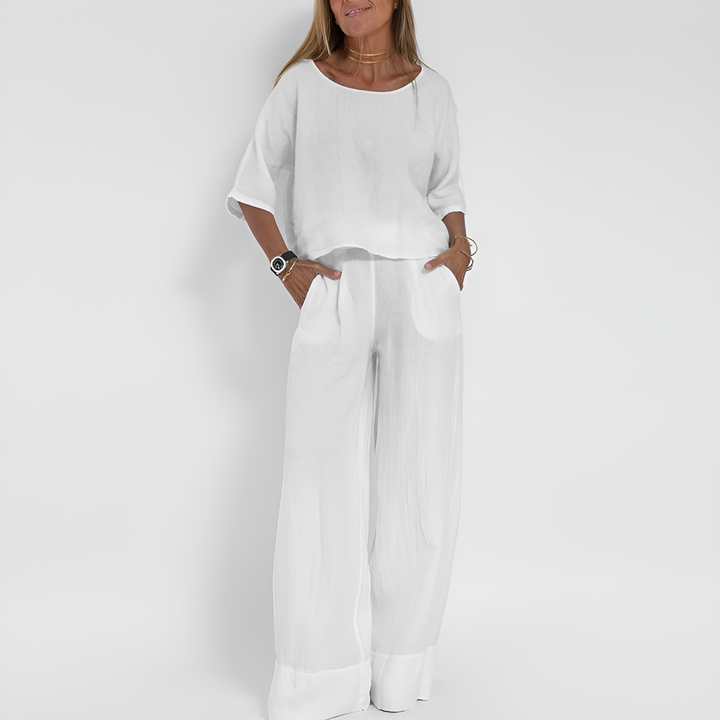 Woman wearing a relaxed fit two-piece summer outfit. Comfortable wide-leg pants & matching top for warm weather.