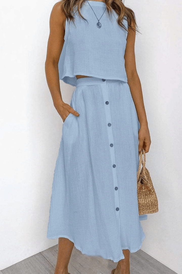 Chic women's co-ord set featuring a relaxed round neck top and a flowy midi skirt for effortless style.