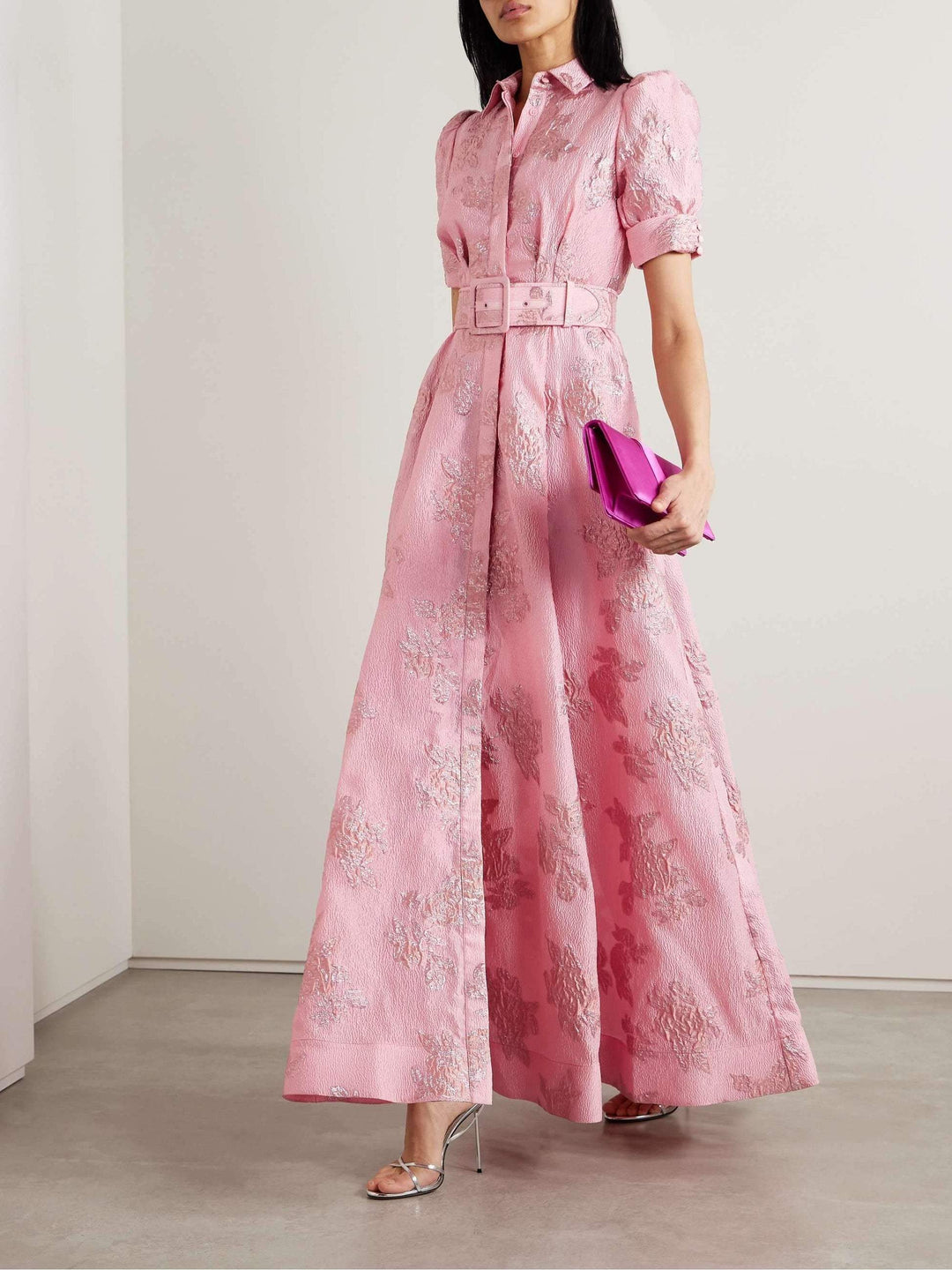 Sophisticated women's pink retro dress with lapel and high waist. Elegant vintage fashion for spring events.
