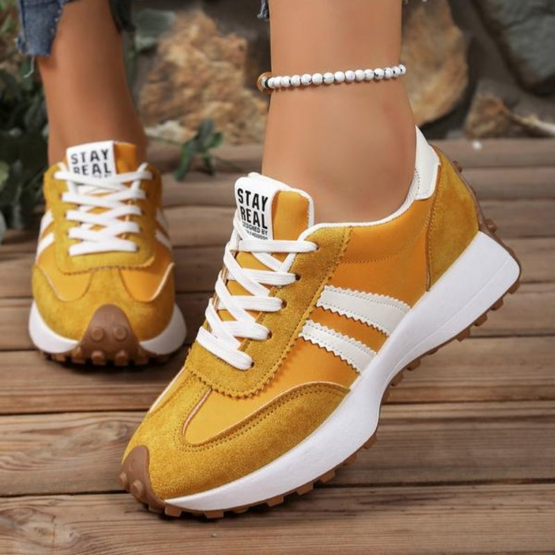 Detail of the chunky platform sole on women's stylish lace-up sneakers, providing height and a trendy look.