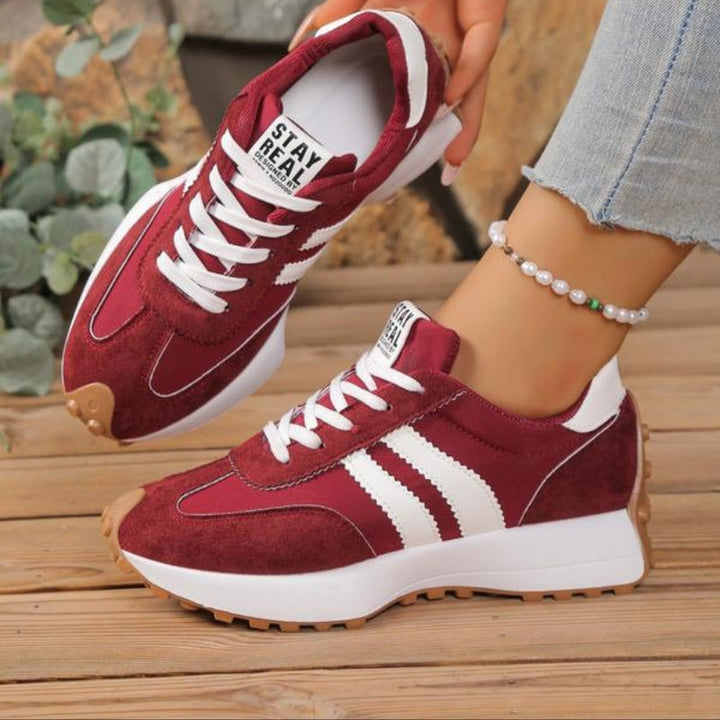 Top-down view of women's fashion platform sneakers, showing the secure lace-up closure and sleek retro silhouette.