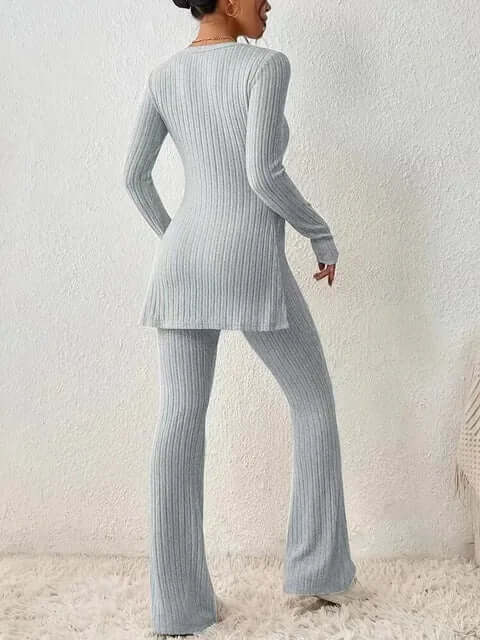 Women's two-piece ribbed knitwear set featuring a long sleeve top and elegant flared trousers.