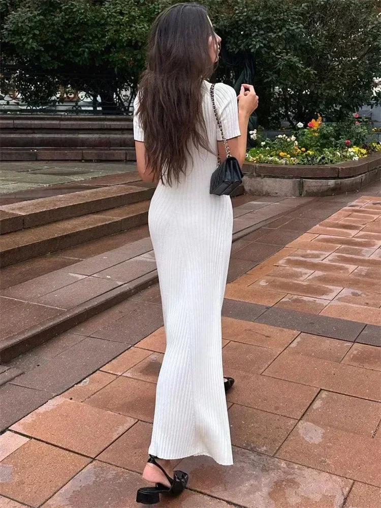 Stylish women's long V-neck ribbed knit dress featuring decorative button detail.