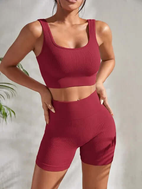 Comfortable women's ribbed activewear set featuring high-waist shorts & a sleeveless yoga top, ideal for workouts.