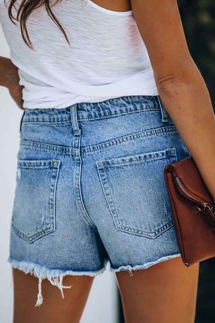 Stylish women's blue ripped slim fit jeans, trendy denim for a casual, fashion-forward look.