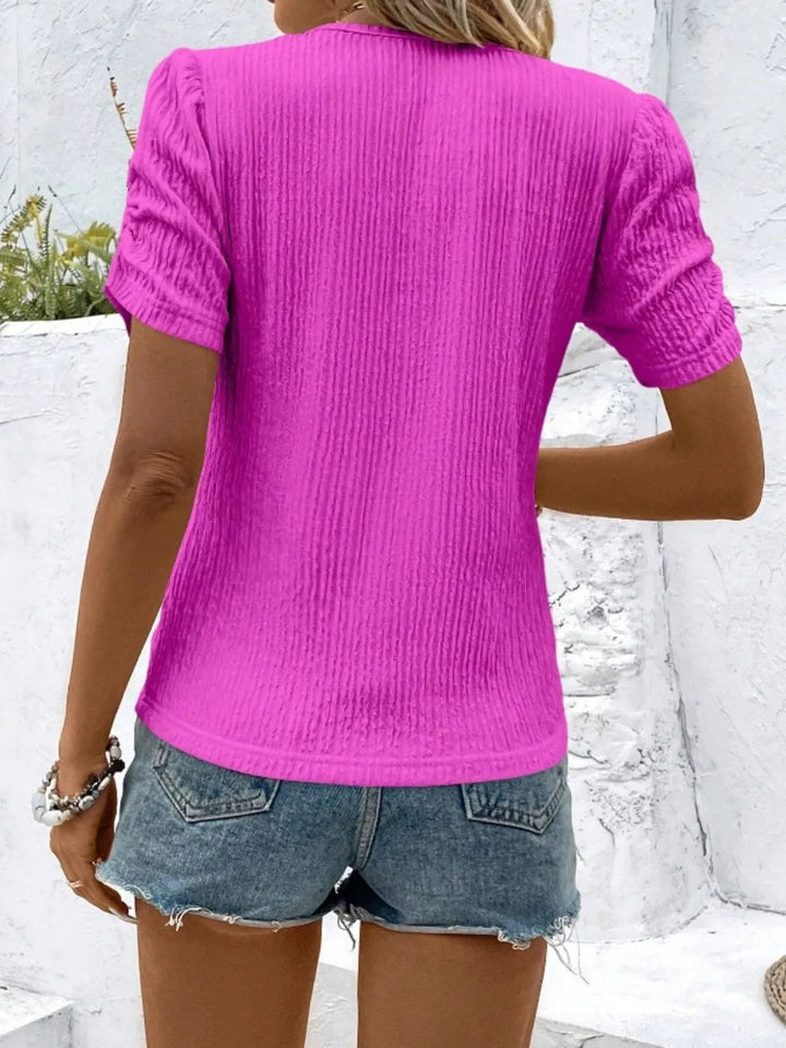 Fashionable women's ruched short sleeve knit top, a fitted blouse for contemporary style.