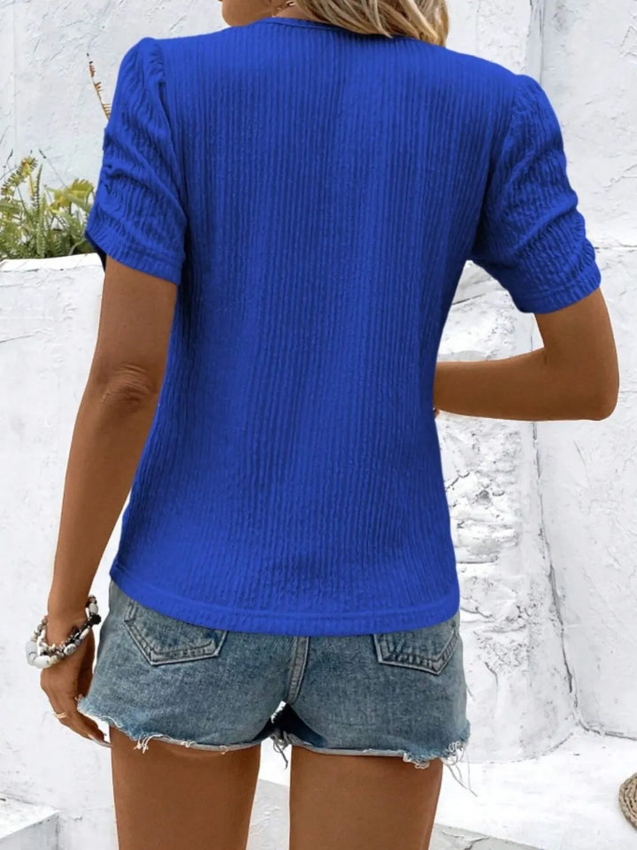 Classic women's fitted knit top with stylish ruched short sleeves.